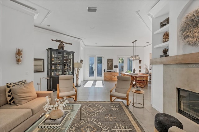 4505 Camino Real, Sarasota, FL 34231 - tiled living room with ornamental molding, french doors, and a glass covered fireplace