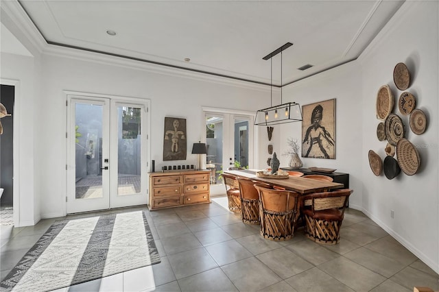 4505 Camino Real, Sarasota, FL 34231 - tiled dining area with french doors, healthy amount of natural light, a tray ceiling, crown molding, and baseboards