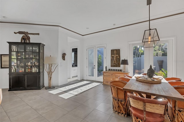 4505 Camino Real, Sarasota, FL 34231 - dining room featuring french doors, light tile patterned floors, and crown molding