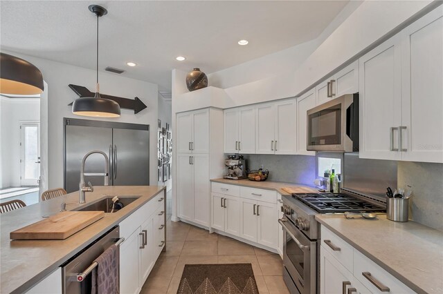 4505 Camino Real, Sarasota, FL 34231 - kitchen featuring stainless steel appliances, light tile patterned floors, light countertops, white cabinetry, and recessed lighting