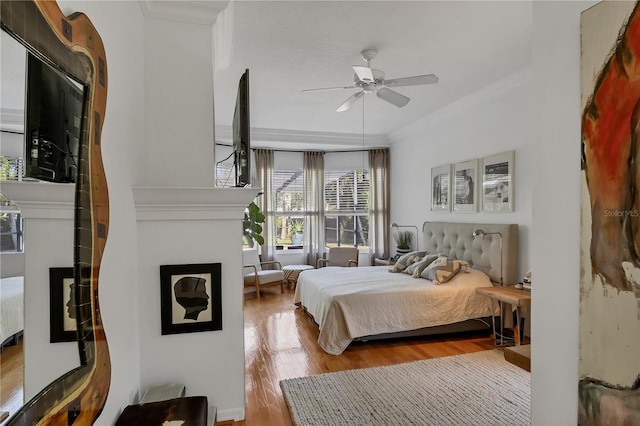 4505 Camino Real, Sarasota, FL 34231 - bedroom with crown molding, wood finished floors, a fireplace, and ceiling fan