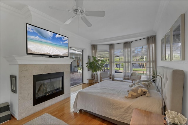 4505 Camino Real, Sarasota, FL 34231 - bedroom featuring ornamental molding, wood finished floors, a premium fireplace, and a ceiling fan
