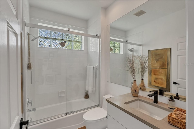 4505 Camino Real, Sarasota, FL 34231 - bathroom with toilet, combined bath / shower with glass door, and vanity