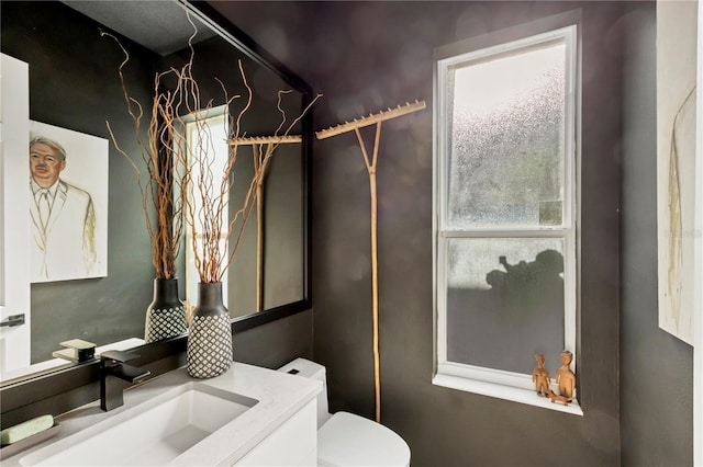 4505 Camino Real, Sarasota, FL 34231 - half bathroom with healthy amount of natural light, toilet, and vanity