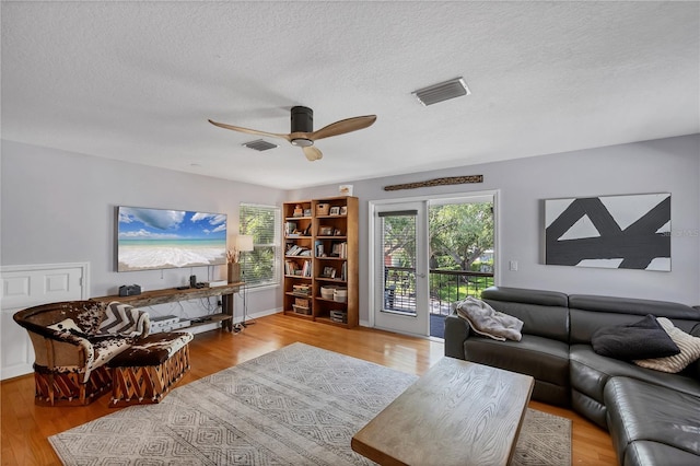 4505 Camino Real, Sarasota, FL 34231 - living room with wood finished floors, ceiling fan, and a textured ceiling