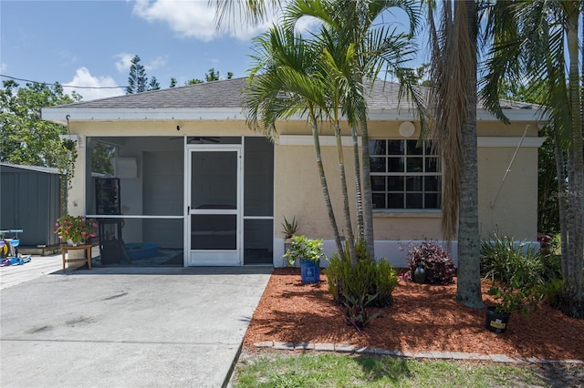 3411 15th St E, Ellenton, FL 34222 - rear view of house featuring a sunroom and stucco siding
