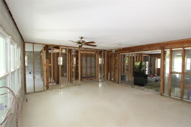 129 Pierson Ln, Sarasota, FL 34242 - unfurnished living room with a ceiling fan and concrete floors
