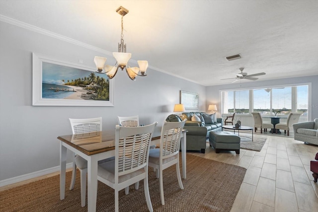 1255 E Peppertree Dr Unit 507, Sarasota, FL 34242 - dining space featuring a chandelier, a ceiling fan, and crown molding
