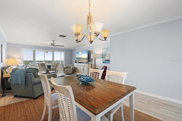 1255 E Peppertree Dr Unit 507, Sarasota, FL 34242 - dining space with light wood finished floors, ornamental molding, a chandelier, a ceiling fan, and baseboards