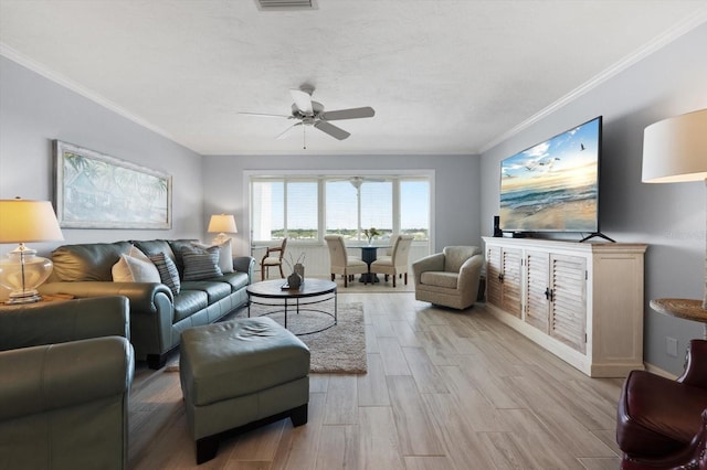 1255 E Peppertree Dr Unit 507, Sarasota, FL 34242 - living area featuring ceiling fan, crown molding, light wood-style floors, and baseboards