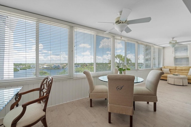 1255 E Peppertree Dr Unit 507, Sarasota, FL 34242 - sunroom with wood finished floors, healthy amount of natural light, and a water view