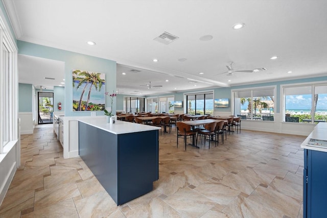1255 E Peppertree Dr Unit 507, Sarasota, FL 34242 - kitchen featuring ceiling fan, recessed lighting, light countertops, plenty of natural light, and a wainscoted wall