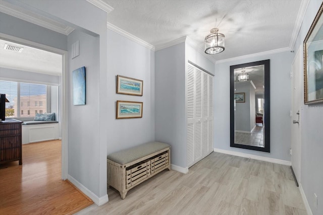 1255 E Peppertree Dr Unit 507, Sarasota, FL 34242 - foyer entrance with light wood-style flooring, a chandelier, ornamental molding, baseboards, and a textured ceiling