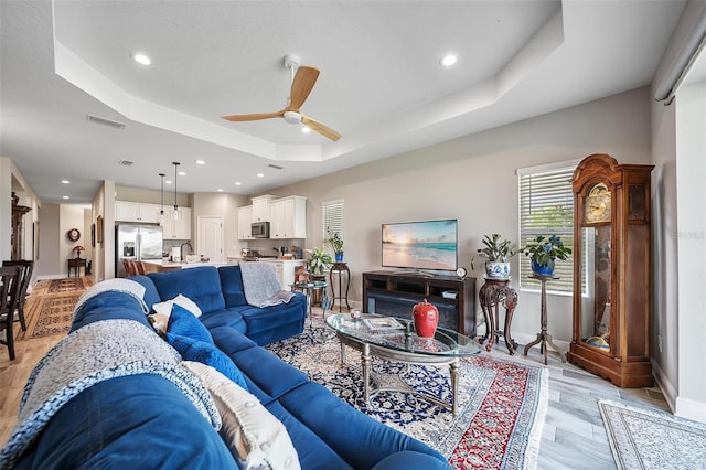 2625 Star Apple Way, Sarasota, FL 34240 - living area featuring a raised ceiling, a ceiling fan, recessed lighting, and baseboards