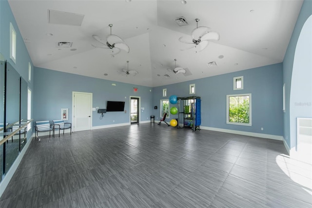2625 Star Apple Way, Sarasota, FL 34240 - unfurnished living room with high vaulted ceiling, a ceiling fan, and baseboards