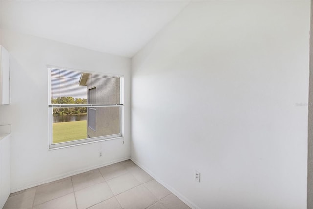 9630 Club S Cir Unit 6303, Sarasota, FL 34238 - empty room with light tile patterned flooring, lofted ceiling, and baseboards