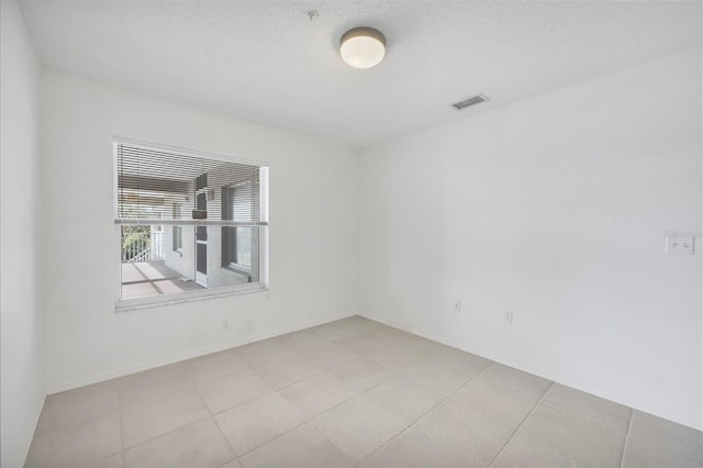 9630 Club S Cir Unit 6303, Sarasota, FL 34238 - tiled spare room featuring a textured ceiling and baseboards