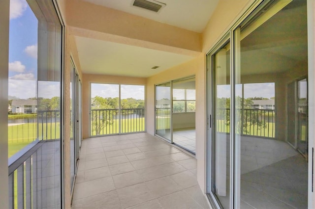 9630 Club S Cir Unit 6303, Sarasota, FL 34238 - unfurnished sunroom featuring a water view and tile patterned floors