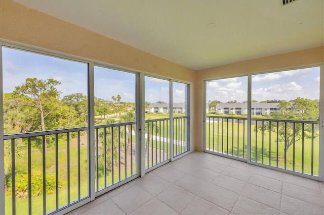 9630 Club S Cir Unit 6303, Sarasota, FL 34238 - unfurnished sunroom featuring tile patterned floors and a residential view