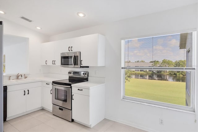 9630 Club S Cir Unit 6303, Sarasota, FL 34238 - kitchen with appliances with stainless steel finishes, light countertops, a sink, white cabinetry, and recessed lighting