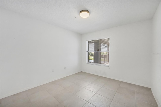 9630 Club S Cir Unit 6303, Sarasota, FL 34238 - unfurnished room with light tile patterned floors, baseboards, and a textured ceiling