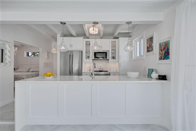 643 Calle Del Otono, Sarasota, FL 34242 - kitchen with high quality fridge, glass insert cabinets, white cabinets, beamed ceiling, and light countertops