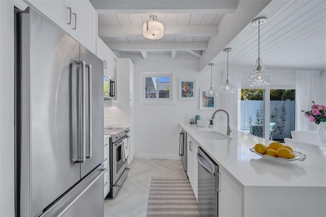 643 Calle Del Otono, Sarasota, FL 34242 - kitchen featuring stainless steel appliances, a sink, a peninsula, white cabinetry, and light countertops