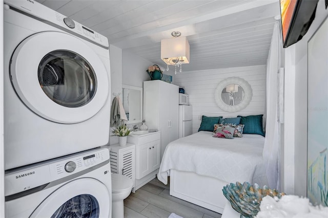 643 Calle Del Otono, Sarasota, FL 34242 - laundry room featuring estacked washer and dryer, wood finished floors, and wood ceiling