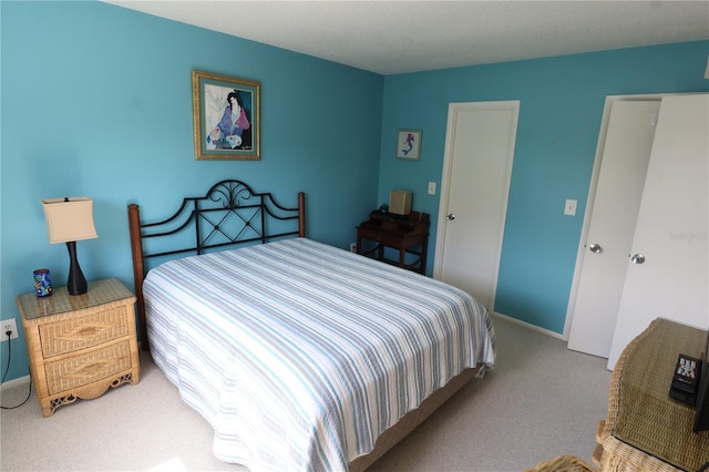carpeted bedroom with baseboards