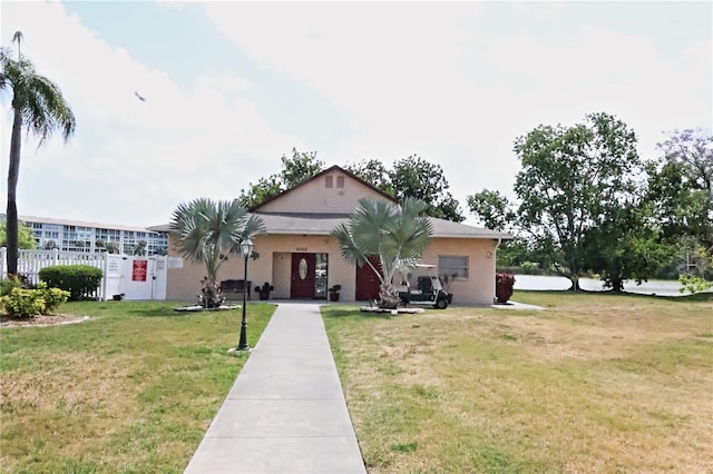 view of front of property featuring a front lawn and stucco siding