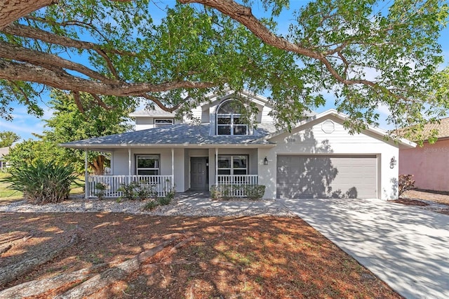 5310 SW 25th Ct, Cape Coral, FL 33914 - view of front of house with covered porch, an attached garage, and concrete driveway