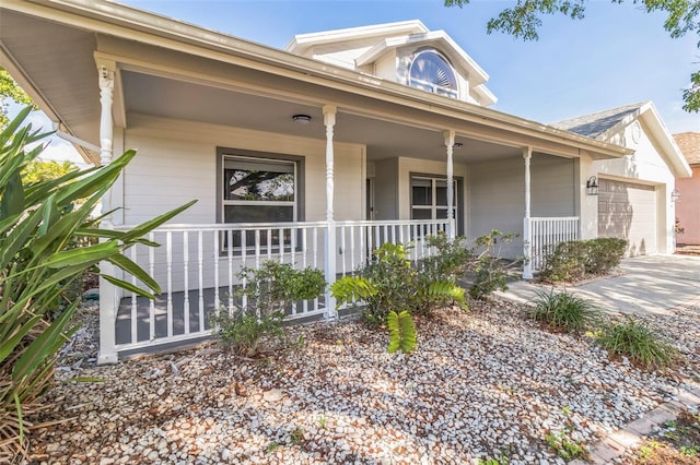 5310 SW 25th Ct, Cape Coral, FL 33914 - view of front of house featuring covered porch, a garage, and concrete driveway