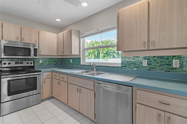 5310 SW 25th Ct, Cape Coral, FL 33914 - kitchen featuring appliances with stainless steel finishes, light brown cabinetry, a sink, and light tile patterned flooring