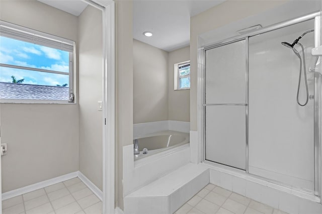 5310 SW 25th Ct, Cape Coral, FL 33914 - bathroom featuring a stall shower, a bath, tile patterned flooring, and baseboards