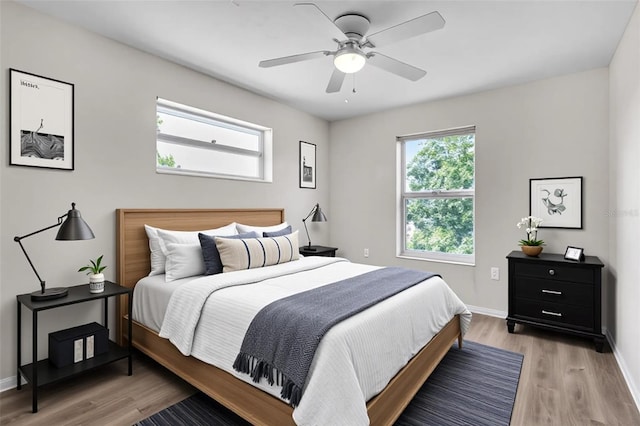 5310 SW 25th Ct, Cape Coral, FL 33914 - bedroom featuring multiple windows, light wood-style floors, and baseboards