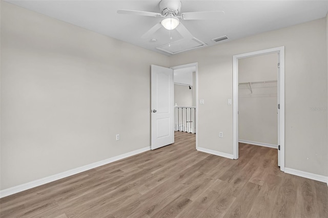 5310 SW 25th Ct, Cape Coral, FL 33914 - unfurnished bedroom featuring light wood finished floors, baseboards, a spacious closet, a closet, and ceiling fan