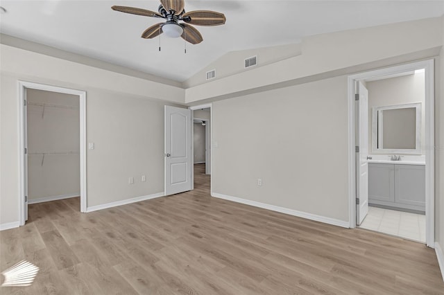 5310 SW 25th Ct, Cape Coral, FL 33914 - unfurnished bedroom featuring light wood-style flooring, lofted ceiling, a walk in closet, baseboards, and ensuite bath