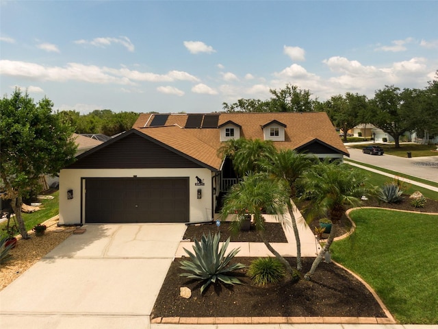 11021 4th Ave E, Bradenton, FL 34212 - view of front of house with solar panels, driveway, a front lawn, an attached garage, and stucco siding