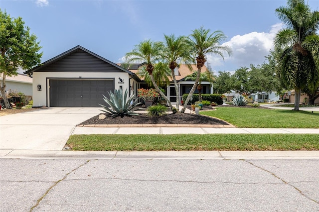 11021 4th Ave E, Bradenton, FL 34212 - view of front facade with an attached garage, driveway, a front yard, and stucco siding