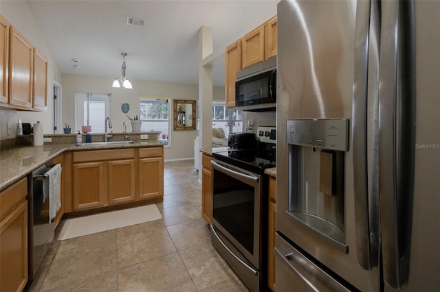 11021 4th Ave E, Bradenton, FL 34212 - kitchen featuring stainless steel appliances, a sink, a chandelier, light stone counters, and a peninsula