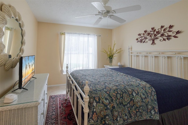 11021 4th Ave E, Bradenton, FL 34212 - bedroom with a ceiling fan, light tile patterned floors, a textured ceiling, and baseboards