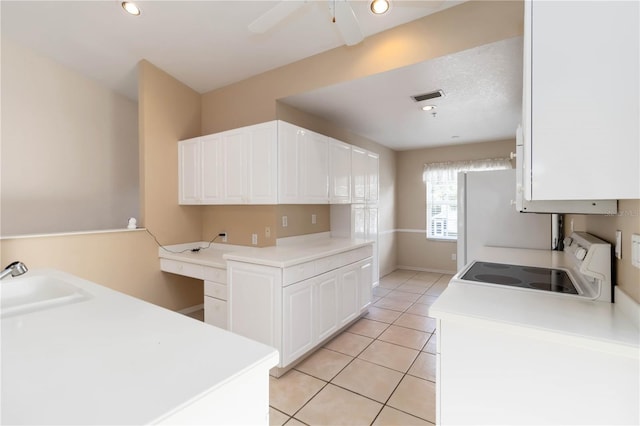 6572 Fairway Gardens Dr Unit 6572, Bradenton, FL 34203 - kitchen with white appliances, white cabinetry, light tile patterned floors, a ceiling fan, and light countertops