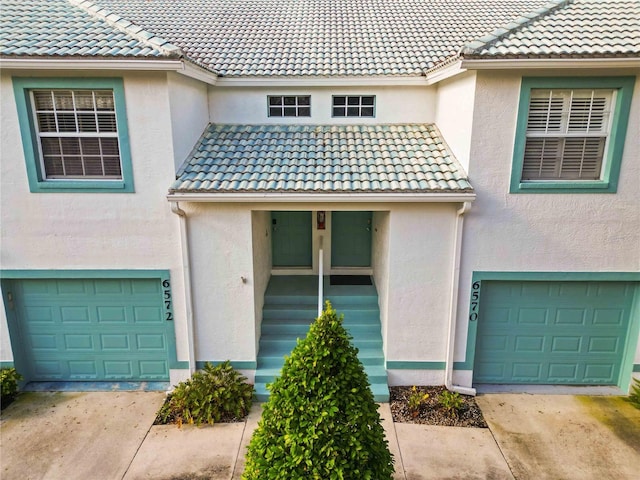 6572 Fairway Gardens Dr Unit 6572, Bradenton, FL 34203 - entrance to property with a garage, a tiled roof, and stucco siding