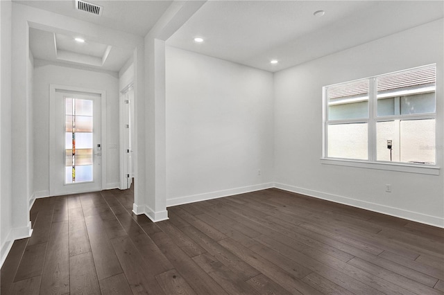 17723 Palmiste Dr, Bradenton, FL 34202 - spare room featuring dark wood finished floors, recessed lighting, and a raised ceiling