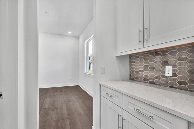 17723 Palmiste Dr, Bradenton, FL 34202 - kitchen featuring dark wood-style flooring, tasteful backsplash, light stone countertops, white cabinetry, and recessed lighting