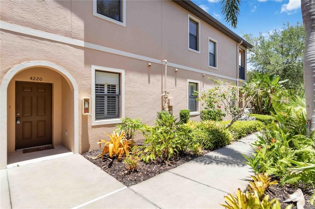 4220 Via Piedra Cir Unit 4-101, Sarasota, FL 34233 - doorway to property with stucco siding