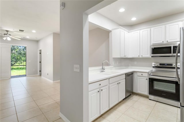 4220 Via Piedra Cir Unit 4-101, Sarasota, FL 34233 - kitchen with a sink, stainless steel appliances, light tile patterned flooring, ceiling fan, and light countertops