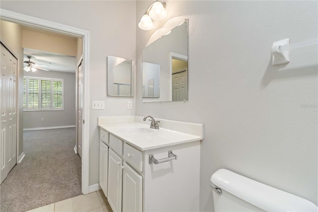 4220 Via Piedra Cir Unit 4-101, Sarasota, FL 34233 - bathroom with toilet, vanity, ceiling fan, and baseboards