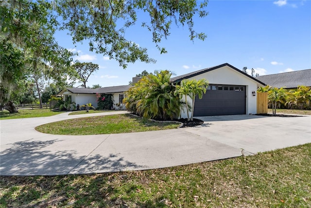 3810 Hidden River Rd, Sarasota, FL 34240 - ranch-style house featuring driveway, an attached garage, and stucco siding