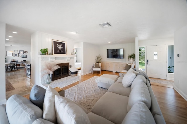 3810 Hidden River Rd, Sarasota, FL 34240 - living area featuring a brick fireplace, baseboards, recessed lighting, and light wood-style flooring